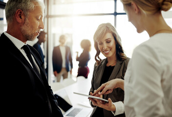 Business people, tablet and conversation for teamwork, discussion or brainstorming in office. Women, mature man and technology for collaboration, together and mentorship as employees with company ceo