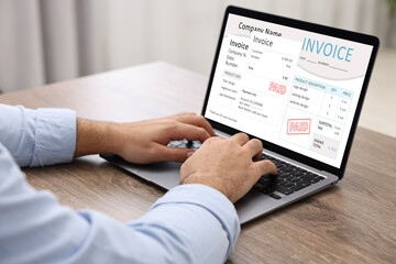 Man using laptop to pay bills at home, closeup