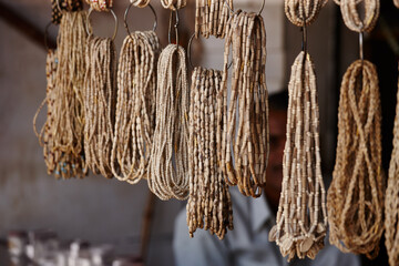 Beads, collection and culture at store outdoor for Indian tradition, religion prayer and spiritual accessories. Retail, design and local craft for jewellery, creative texture and colourful decoration