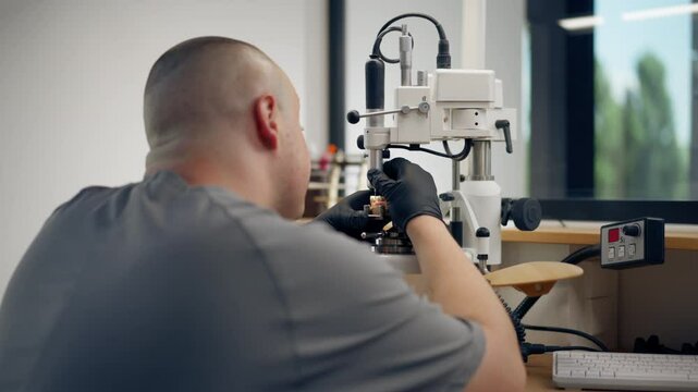 professional laboratory for the production of dental protoses veneers and crowns a specialist adjusts a crown to the shape of a person's jaw gums professional equipment