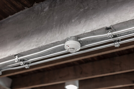 Smoke detector, fire alarm detector indoor home safety device with IMC metal pipeline at ceiling