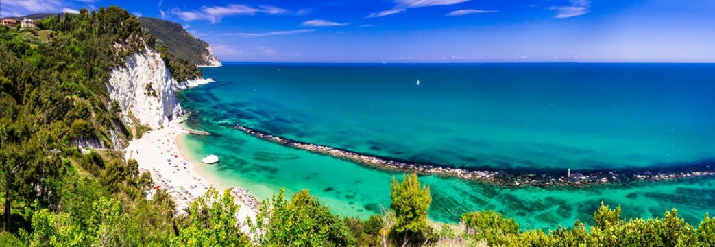 High resolution ultrawide panorama of Spiaggia del Frate and Monte Conero Riviera in Marche Italy. World Print quality scenic sea landscape and turquoise Adriatic coast at summer holidays