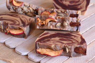 Christmas gifts soap bar handmade crafting diy homemade presents cinnamon apple orange chocolate aroma, brown color wood background, ecological soapmaking, organic bio cosmetics