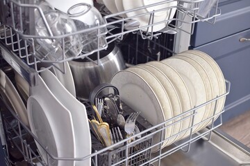 Open dishwasher with dirty dishes