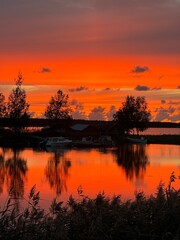 Pink and red beautiful sunset over a lake in finlands archipelago. Landscape view over the ocean. 
