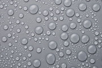 Macro photo. Water drops on a gray background. Top view.