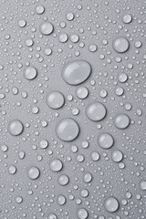 Water drops on abstract gray background. Macro photo. Top view.