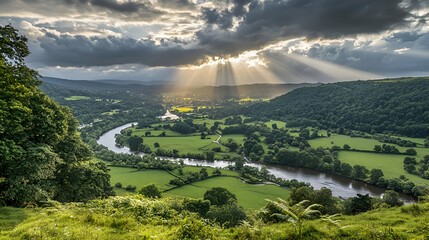 Sunbeams break through dramatic storm clouds over a winding river valley.