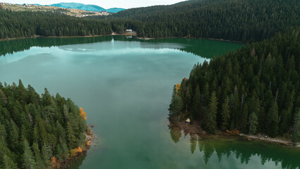 Fototapeta premium Top aerial view from drone of Black Lake - Crno Jezero. Calm autumn landscape scene of Durmitor National Park, Zabljak location in north of Montenegro Europe. Beauty of nature concept.
