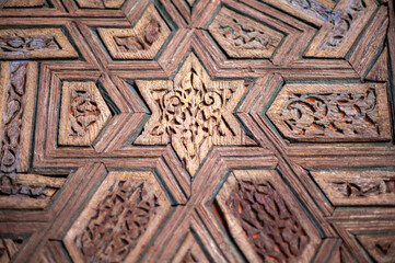 Ornamental colourful geometric medieval ceramic tiles of walls in old castle, Sevilla or Granada, Andalusia, Spain. Arabic ornament background wallpaper