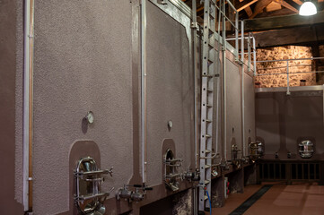 Old concrete tanks for first fermentation of grapes on Bordeaux winery, Saint-Emilion wine making region picking, sorting with hands and crushing Merlot or Cabernet Sauvignon red wine grapes
