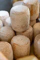 Weekly farmers market in Sarlat-la-Caneda, Dordogne, french cheeses from farm, small goat cheese tommette from Pyrenees
