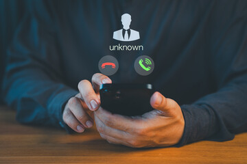 Concept of scam, fraud with a phone from the scammer. Person answering the incoming call. Phone call was from an unknown number. Call center gang or stranger. Hoax person with a fake identity.