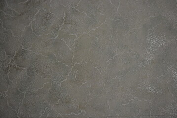 Repairs, construction works. Beautiful grey silver paper wallpaper pasted on the wall.