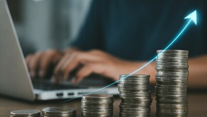 A person typing on a laptop with ascending coin stacks and an upward trend arrow overlay.