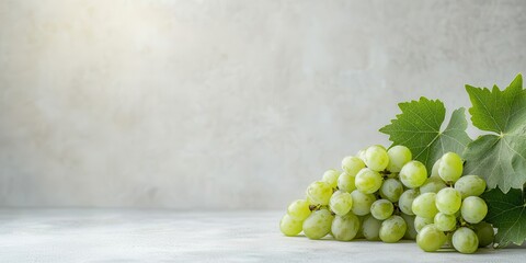 Fresh green grapes with leaves on rustic background.