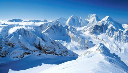 Obraz premium Snow-Covered Mountain Peaks with Blue Sky and Clouds