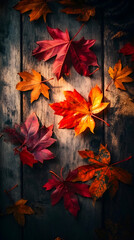 Vibrant autumn leaves scattered on a weathered wooden surface.