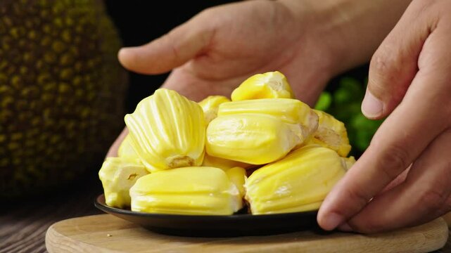 Ripe jackfruit peeled tropical fruit on table.