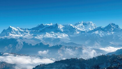 Obraz premium Snowy Mountain Range with Fog and Blue Sky