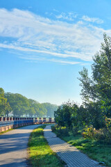 Scenic Riverside Pathway on a Sunny Day - Ideal for Nature Walks and Outdoor Relaxation