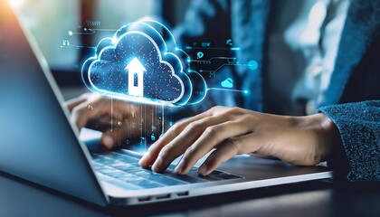 Hand typing on laptop keyboard with cloud icon and data transfer symbol overlay, showing cloud computing.