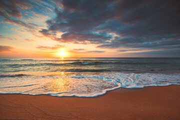 Beautiful cloudscape over the sea water and tropical beach at sunrise or sunset