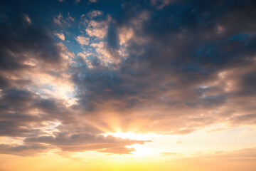 Sunset dramatic sky clouds with sunbeam