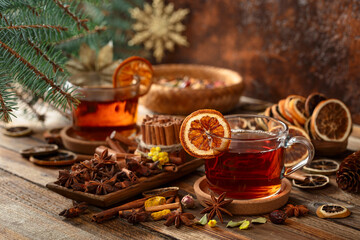 Christmas herbal tea with ingredients on a old wooden table.