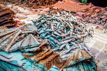 Mixed dried fish are displayed and sold at a street fish market