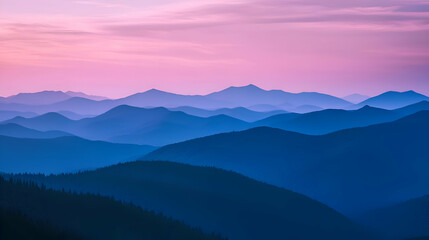 Obraz premium Silhouetted mountain ranges at sunset with a pink and blue sky.