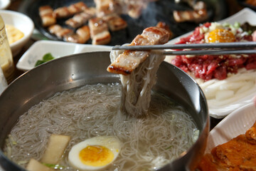 Korean food. cold buckwheat noodles with pork belly bbq