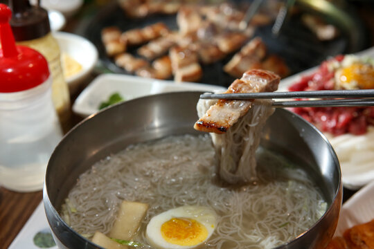 Korean food. cold buckwheat noodles with pork belly bbq