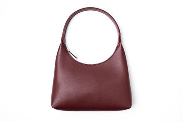 Women's leather bag in burgundy color isolated on white background top view. Fashionable stylish...