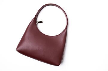 Women's leather bag in burgundy color isolated on white background top view. Fashionable stylish...