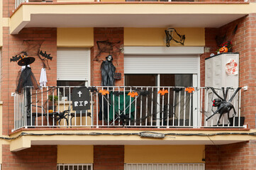 An apartment balcony decorated for Halloween with various spooky elements including a skeleton,...
