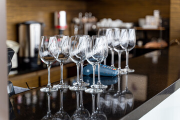 A stylish arrangement of wine glasses displayed gracefully on a bar counter in a chic