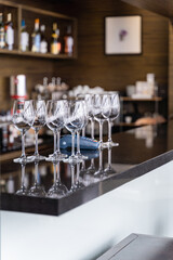 A stylish arrangement of wine glasses displayed gracefully on a bar counter in a chic