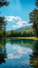 Tranquil lake scene with mountains and blue sky reflecting on the water.