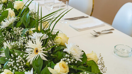 Beautiful flowers decorated on the table. Tables set for an event party or wedding reception. luxury elegant table setting dinner in a restaurant.