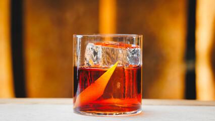 Negroni cocktail on a light warm background. Bar, party, day off, holiday.