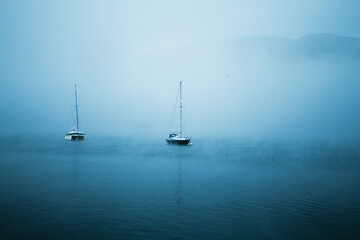 Fototapeta premium Moody Sailing Boat on a blue Lake in Scotland Nature Landscape Travel