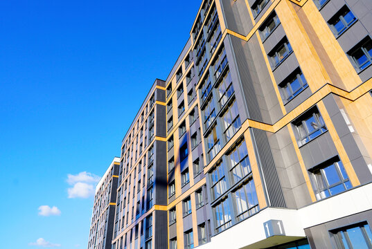 Modern facade building. Facade of high rise urban Modern house. balcony and Windows . Architecture building exterior, house block. High Rise house. Residential development in UK. City built. Blue sky.