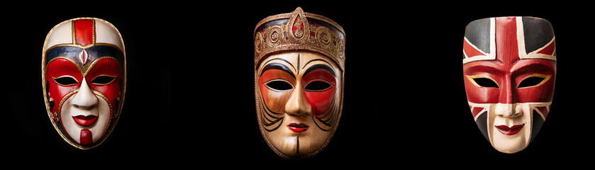 Three colorful masks with intricate designs are isolated against a black background.