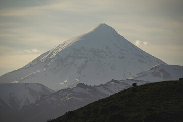 Fototapeta premium Snowy peak of Lanin volcano in Lanin National park by sunrise