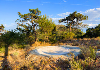 Artificial pond with water for animals and birds in Spain mountains. Watering hole for animals and...