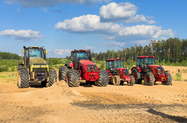 Farm tractor for harvesting crops. Farm tractors for harvesting crops in a farmer's field. Agricultural equipment for working in the field.