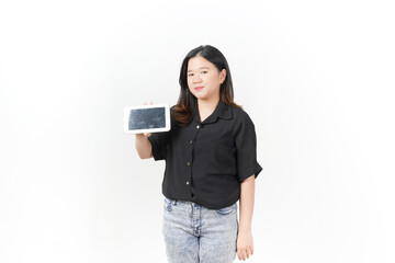 beautiful Asian woman smiles while holding a blank black smartphone and pointing at the screen against a white background