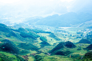 Fototapeta premium a green valley with a road in the background