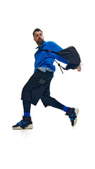Fashion-forward man in vibrant blue outfit, captured mid-movement with dynamic twist. against white studio background. Concept of fashion and style, beauty, trendy, sport and casual. Ad